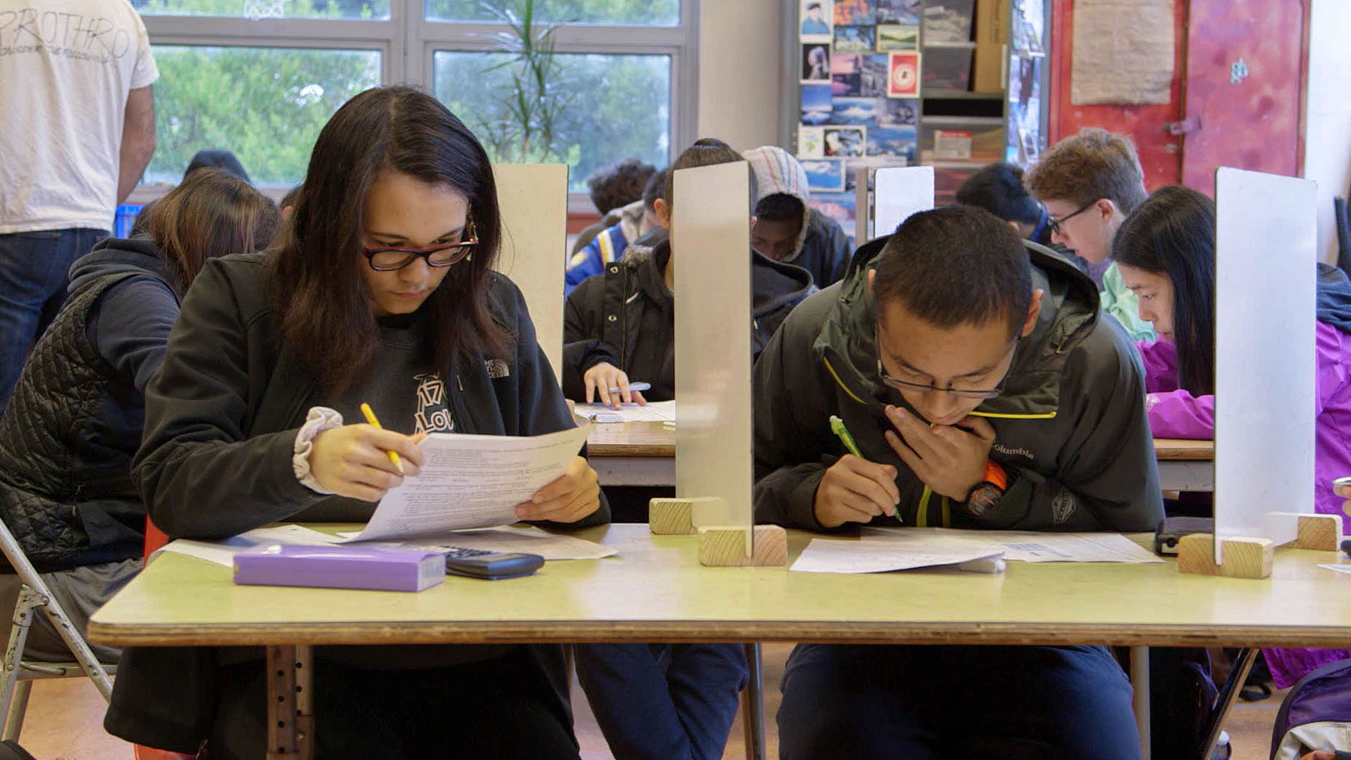 Rachael and a peer take a test at Lowell High