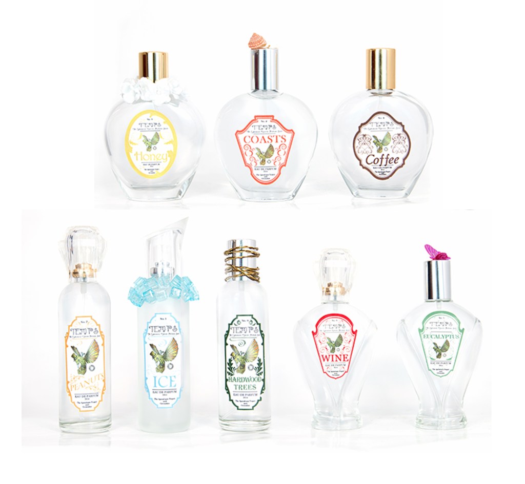 A photo of perfume bottles with colorful labels.